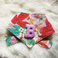 Colorful fabric with floral patterns and a letter 'B' INITIAL 
on a white fur background