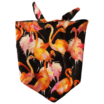 A bandana with a pattern of orange, pink, and black flamingos on a black background, designed for small to medium dogs.