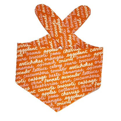 Orange dog bandana with white fruit and vegetable text on a white background